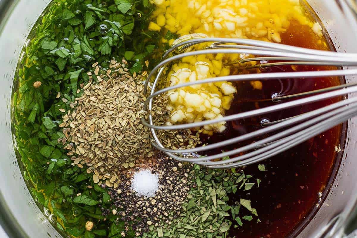 Whisking together all dressing ingredients in a jug.
