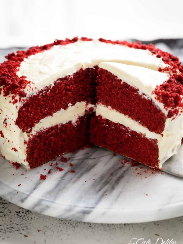 The most incredible Red Velvet Cake with Cream Cheese Frosting is fluffy, soft, buttery and moist with the most perfect velvet texture! Super easy to make with a few tips and tricks for the best results! You will go crazy for a second slice!