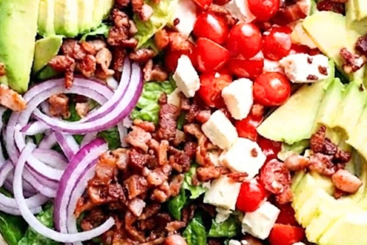 Assemble the lettuce, avocado, feta, tomatoes, red onion, and bacon in a large salad bowl