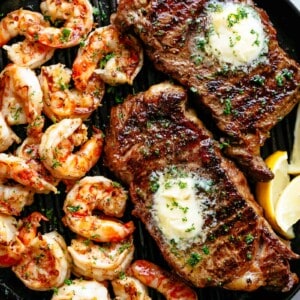 Top view of Grilled Steak & Shrimp slathered in garlic butter.