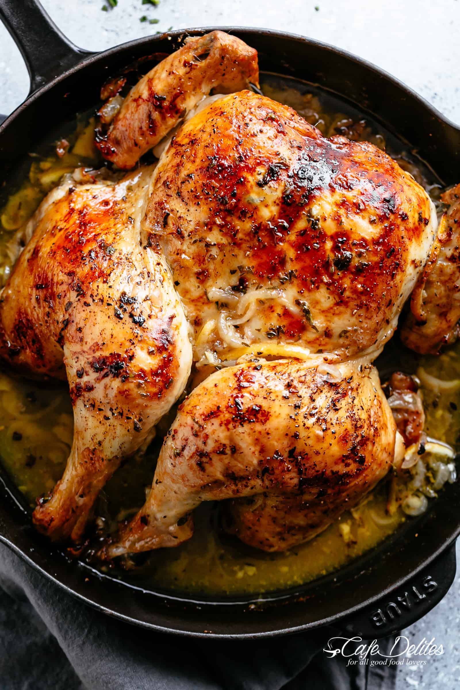 Crispy Spatchcocked Lemon Garlic Roast Chicken in a skillet. 