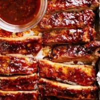 Oven Barbecue Ribs slathered in the most delicious sticky barbecue sauce with a kick of garlic and optional heat! Juicy melt-in-your-mouth oven baked Barbecue Pork Ribs are fall-off-the-bone delicious! Double up on incredible flavour with an easy to make dry rub first, then coat them in a seasoned barbecue sauce mixture so addictive you won't stop at one! Finger licking good ribs right here!
