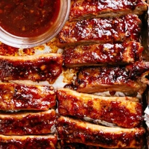 Oven Barbecue Ribs slathered in the most delicious sticky barbecue sauce with a kick of garlic and optional heat! Juicy melt-in-your-mouth oven baked Barbecue Pork Ribs are fall-off-the-bone delicious! Double up on incredible flavour with an easy to make dry rub first, then coat them in a seasoned barbecue sauce mixture so addictive you won't stop at one! Finger licking good ribs right here!