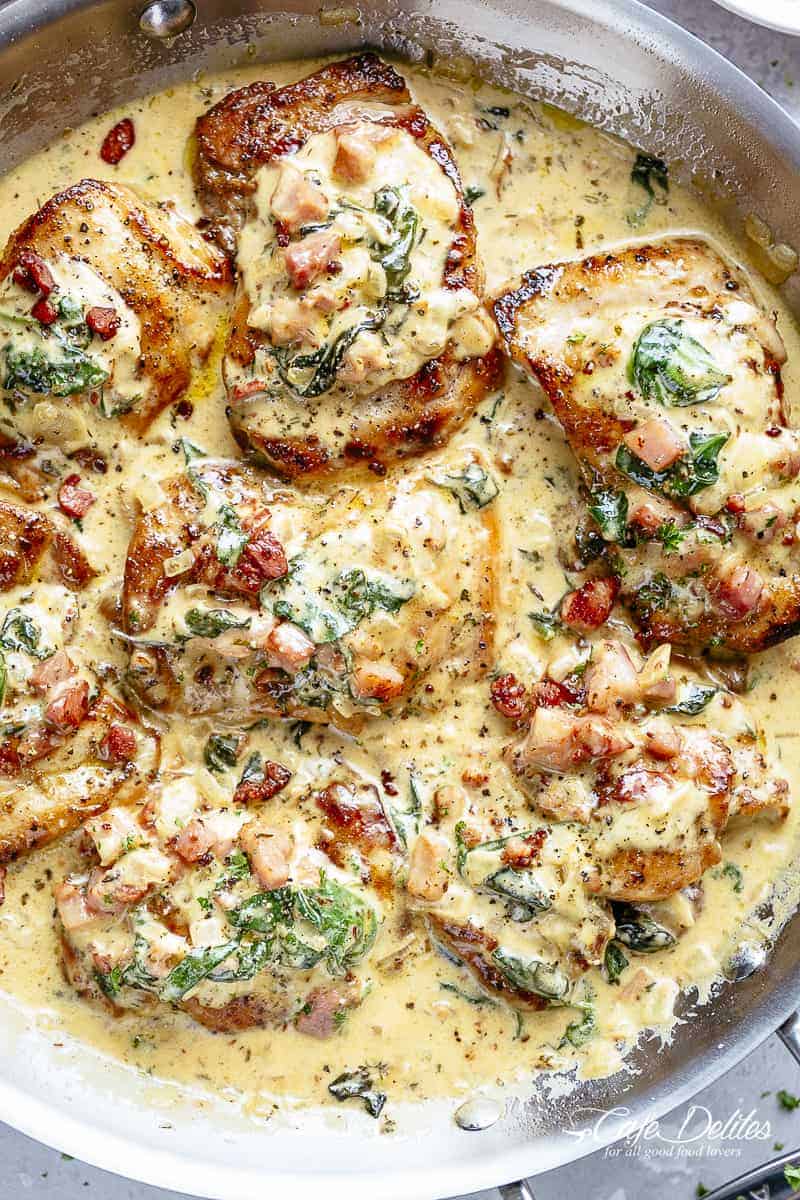 Creamy Dijon Chicken | cafedelites.com Top view of Crispy seared Chicken Thighs in a smooth and creamy garlic Dijon sauce with Bacon pieces and Spinach