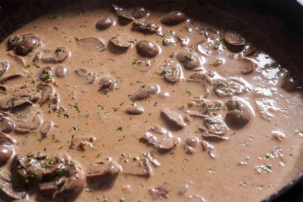 Cream sauce being simmered and brought to a gentle simmer until slightly thick.