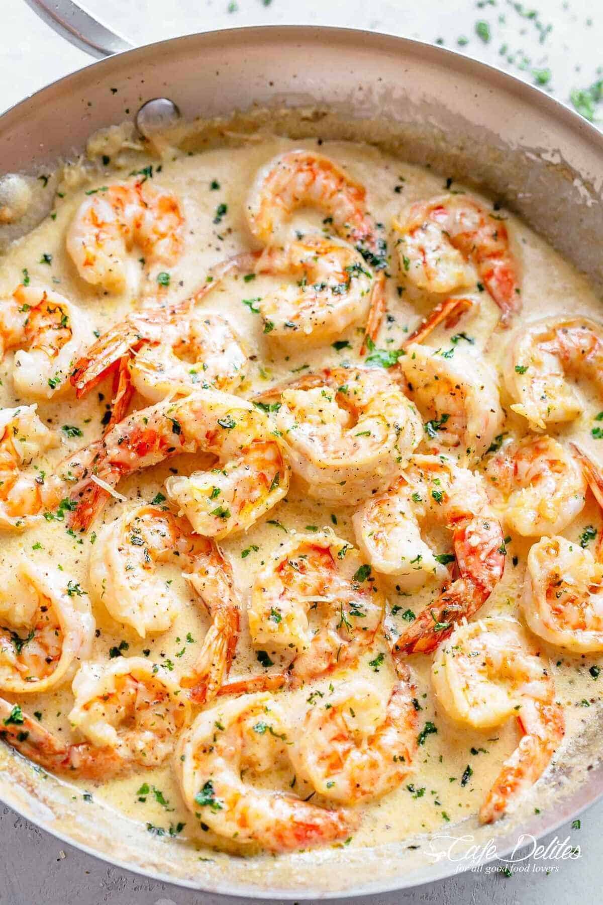 Creamy Garlic Parmesan Shrimp | cafedelites.com Close-up shot of succulent shrimp covered in a creamy garlic sauce with parmesan, garnished with fresh parsley.