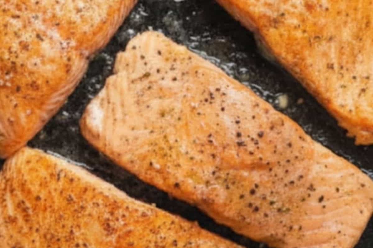 Place the salmon fillets in the pan and cook for 4 minutes per side.