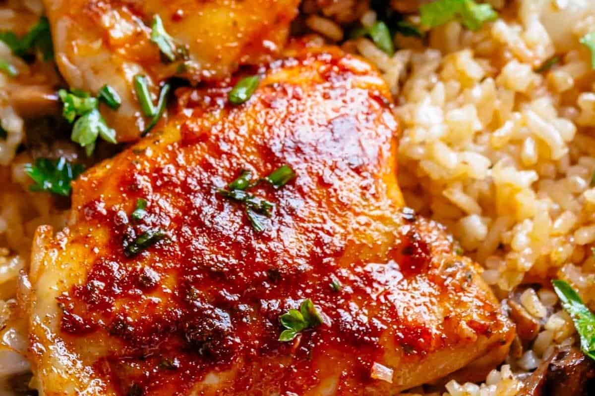 Portion out the rice on a plate, add a spoonful of sauteed mushrooms and mix. Top with chicken thighs.