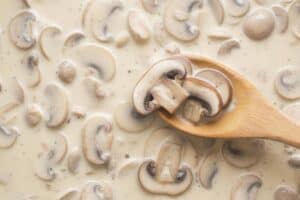 Cooking the creamy mushroom sauce.