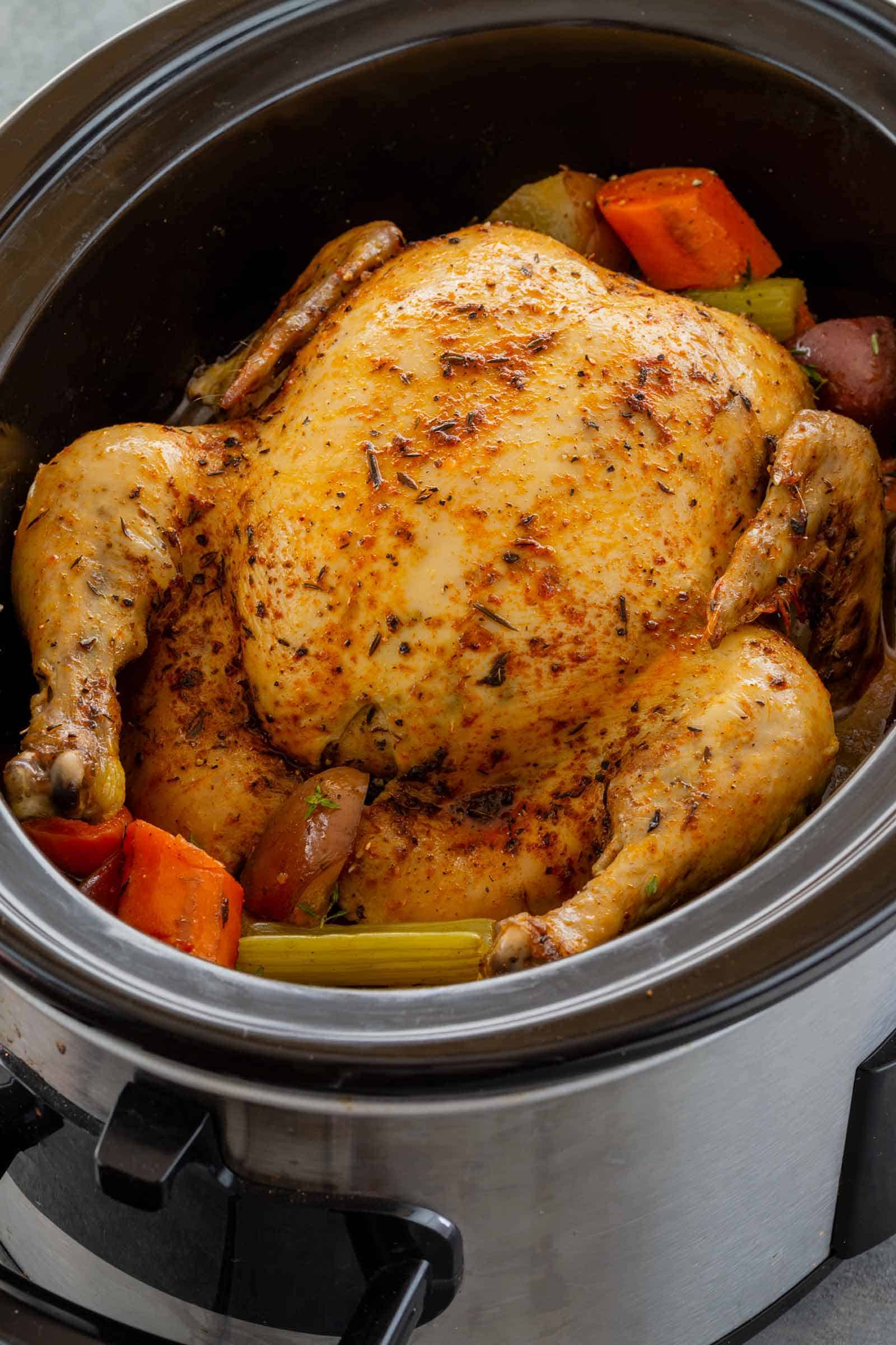 Half cooked full size chicken in a pot