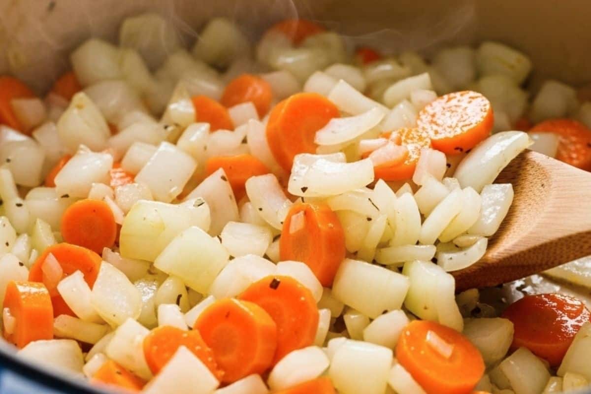 in the same pot, add diced onions, carrots, salt and pepper.