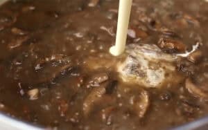 adding the cream to the broth and mushrooms