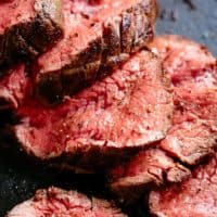 The best, juicy roast Beef Tenderloin slathered with garlic butter that melts in your mouth with every bite! Even better when served with a rich and rustic, easy to make red wine sauce (or jus).