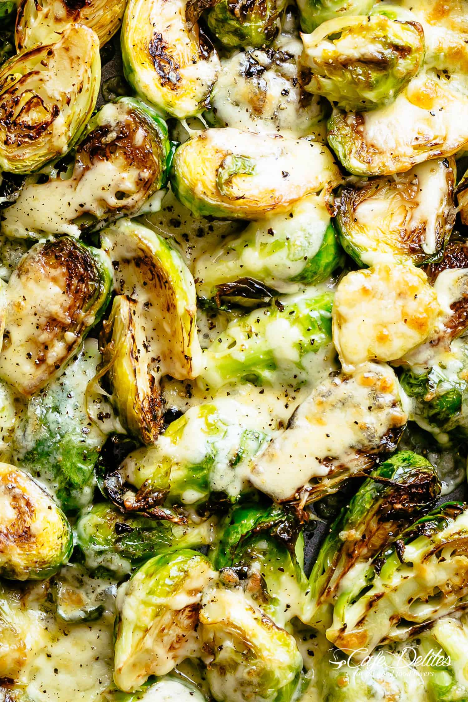 Brussels Sprouts taste good | cafedelites.com Top view image of Cheesy Garlic Roasted Brussels Sprouts Recipe caramelized and topped with melted mozzarella cheese!