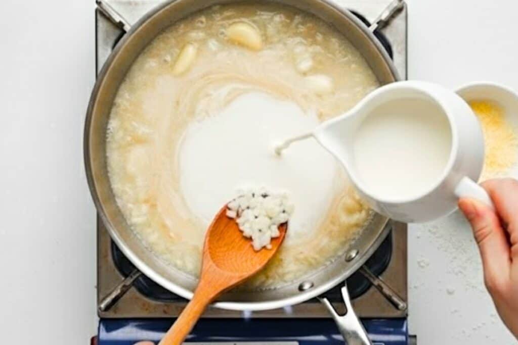 Pour in the cream and let this simmer for a few minutes. Now mix in the Parmesan cheese