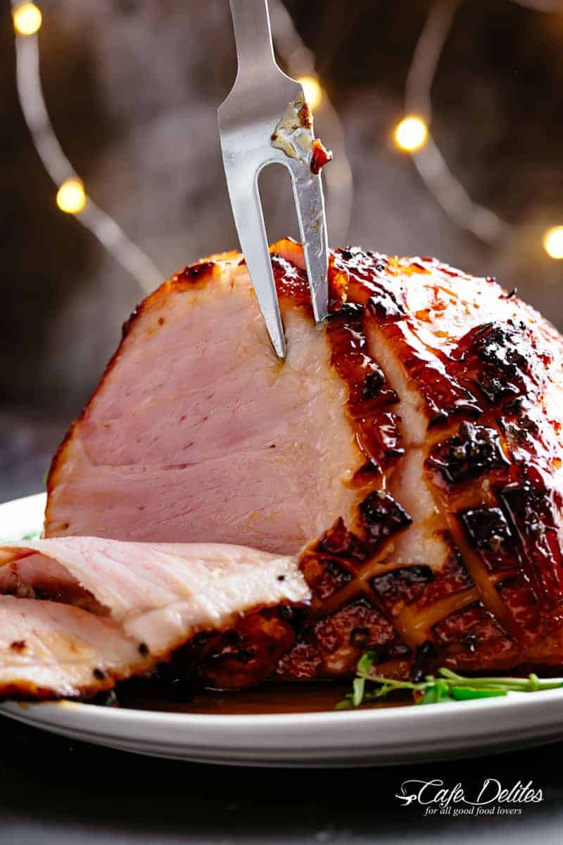 Honey Baked Ham basted with a hint of pineapple juice and a buttery sticky glaze, Juicy and succulent on the inside with crispy, charred, sticky edges.