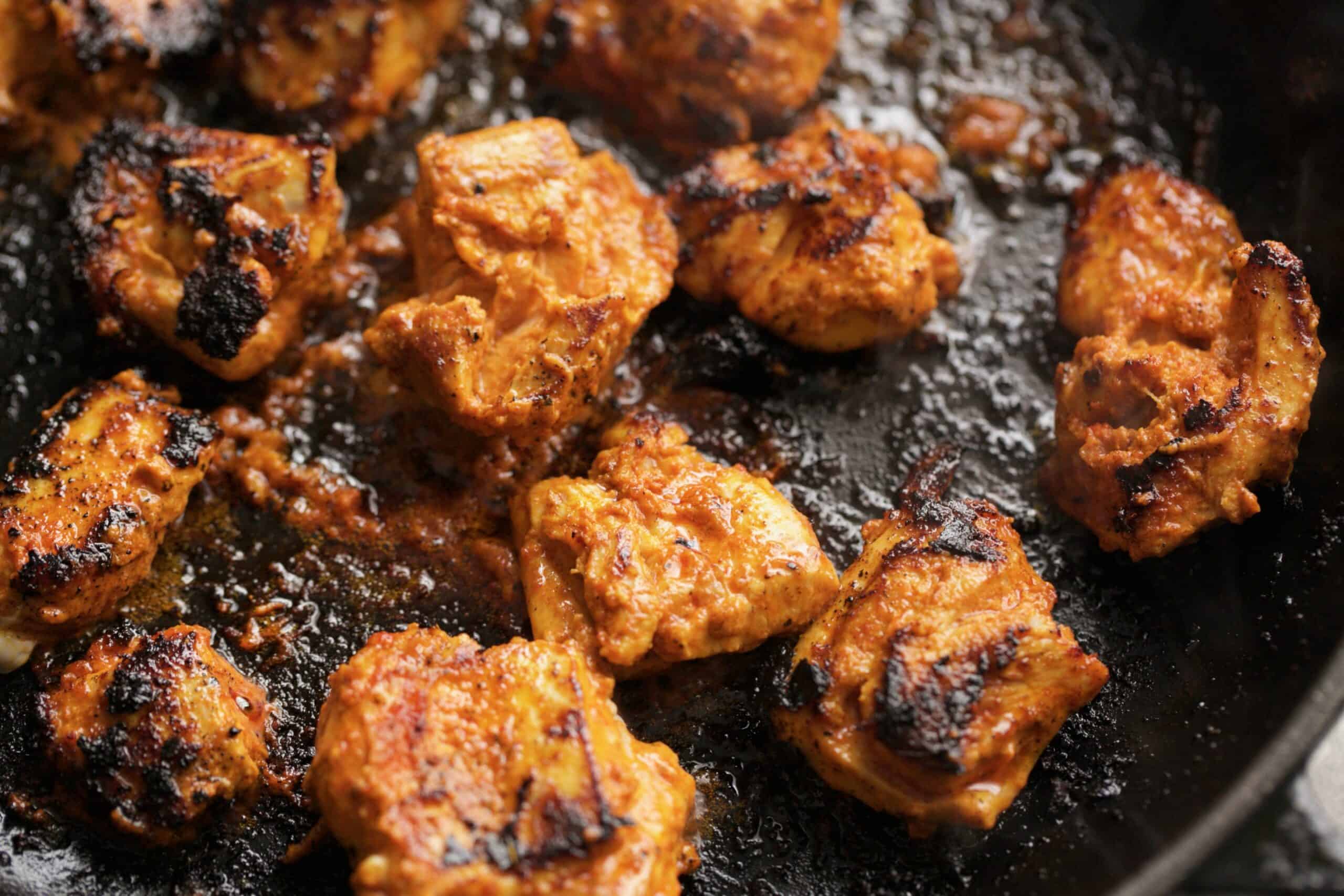 chicken being cooked in a pan