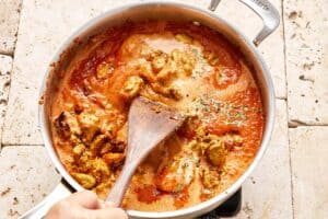 Image of chicken and sauce combined in a pan.