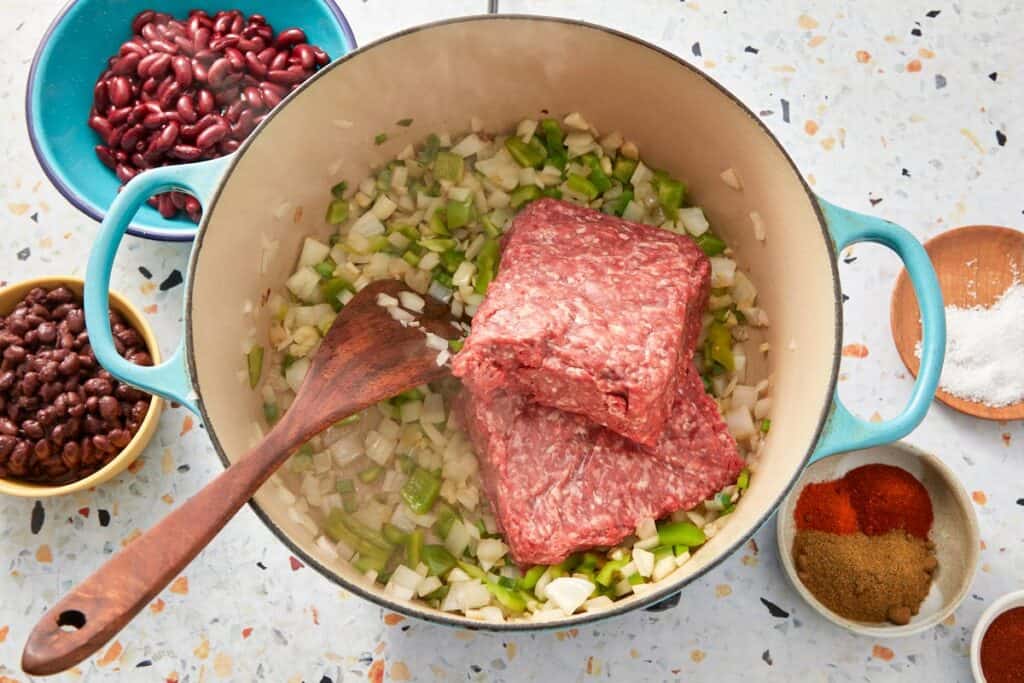 Raw beef in a pot with aromatics