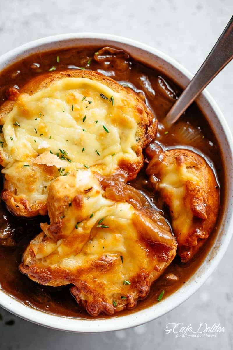 A bowl of French onion soup with garlic cheese bread #cafedelites #soup #French #onion #cheese #garlic #bread Classic French Onion Soup finished off with garlic bread and two types of melted cheese