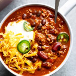 Close Up of beef chili with jalapenos served in a bowl