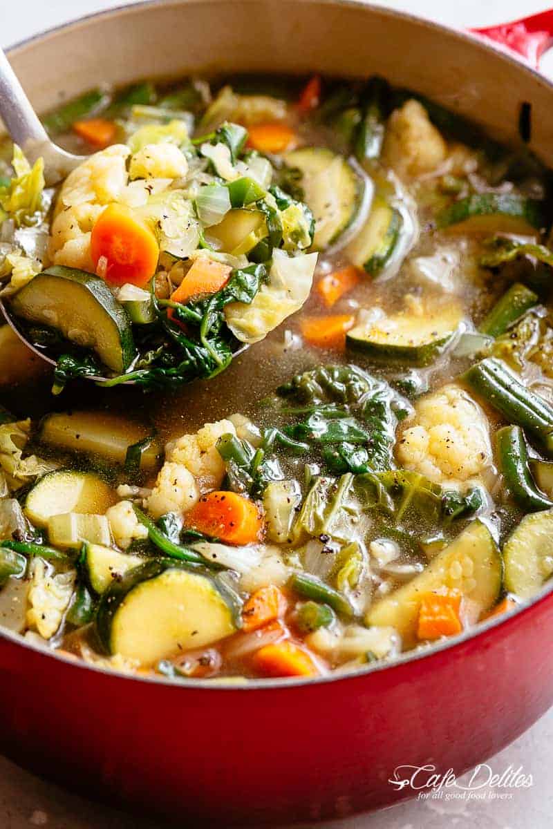 Vegetable Soup | cafedelites.com Zoom in image of A ladle scooping vegetable soup from a large pot.