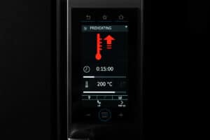 Oven preheating to 200°C on digital display.