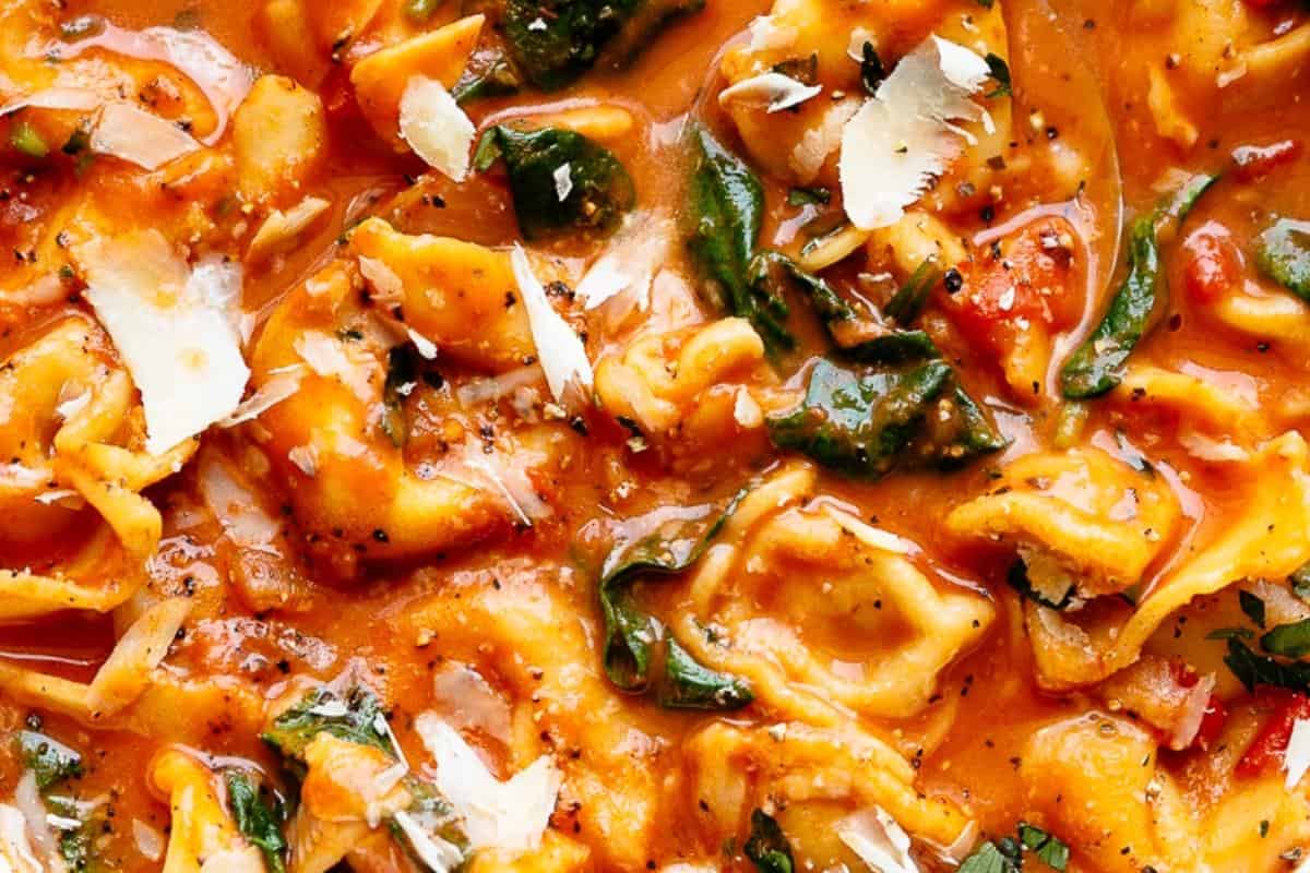 Stir in the cream and tortellini, cook on medium-low until tortellini is just cooked, (about 6-7 minutes). Add the parmesan cheese, spinach and basil; stir until wilted. Serve warm.