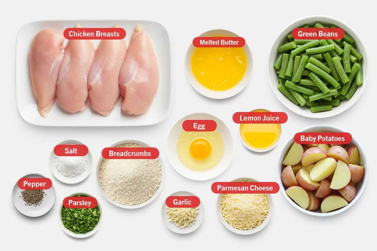 Top shot of ingredients: Chicken breasts, melted butter, green beans, pepper, salt, parsley, breadcrumbs, garlic, egg, lemon juice, parmesan cheese, and baby potatoes.