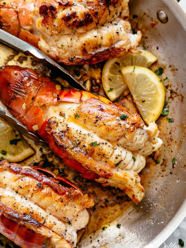 Stove Top Garlic Butter Seared Lobster Tails with lemon wedges