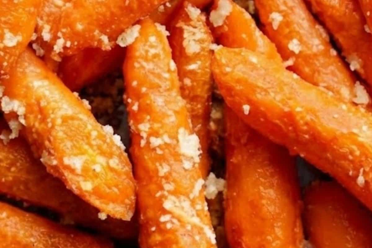 Arrange carrots on the sheet, then add the olive oil, garlic, parmesan, breadcrumbs, salt, and pepper and toss the carrots are evenly coated.