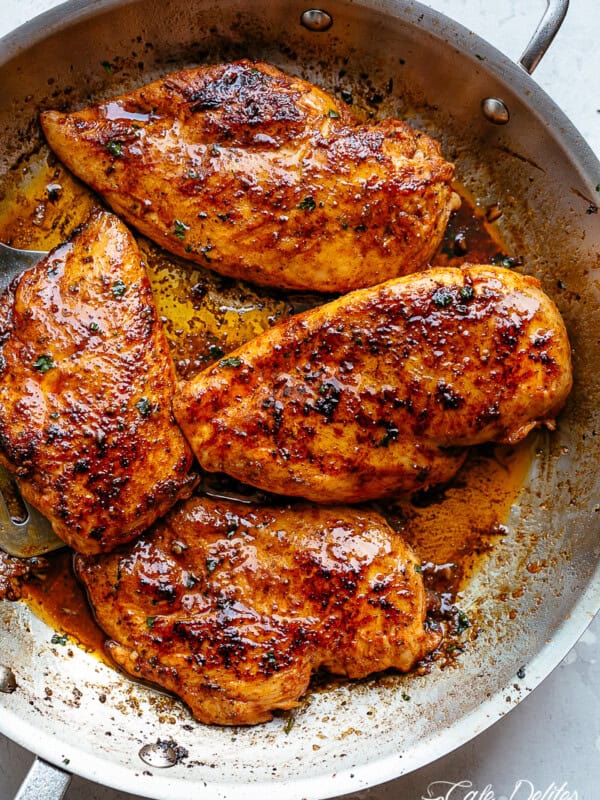 Four Spicy Cajun butter chicken breast pieces, slightly charred in a silver pan.