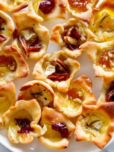A plate full of the crisp baked brie bites.