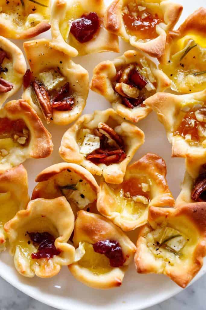A plate full of the crisp baked brie bites.