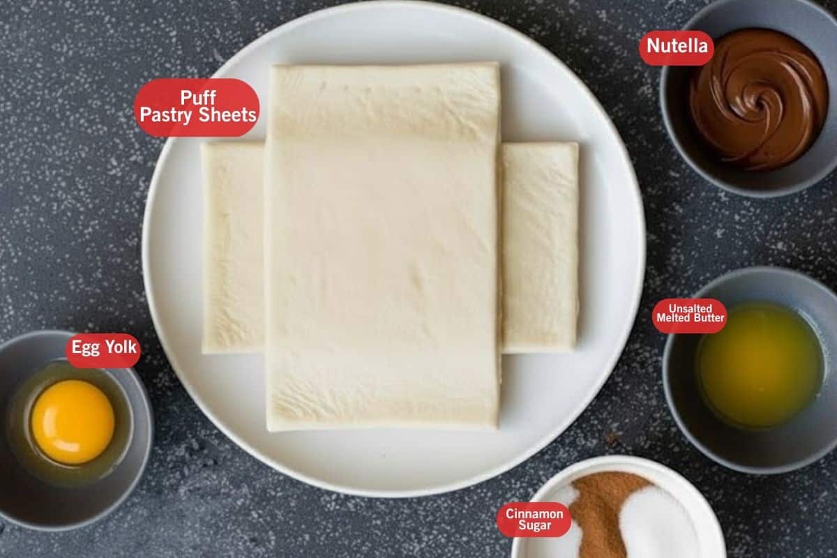 Flat lay photo of ingredient shot of puff pastry sheets, Nutella, egg yolk, unsalted melted butter, cinnamon  mixed  white sugar