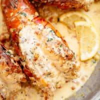 Lobster Tails with Bacon Cream Sauce and served with lemon slice