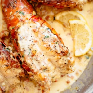 Lobster Tails with Bacon Cream Sauce and served with lemon slice