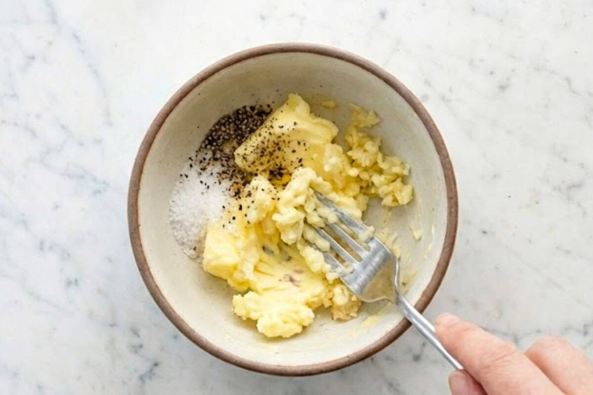 In a small bowl, mix together the softened butter, minced garlic, and half of the salt until smooth