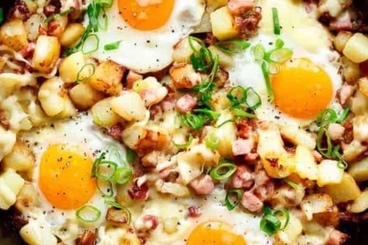 Make four wells in the hash, crack an egg into each, and scatter mozzarella.