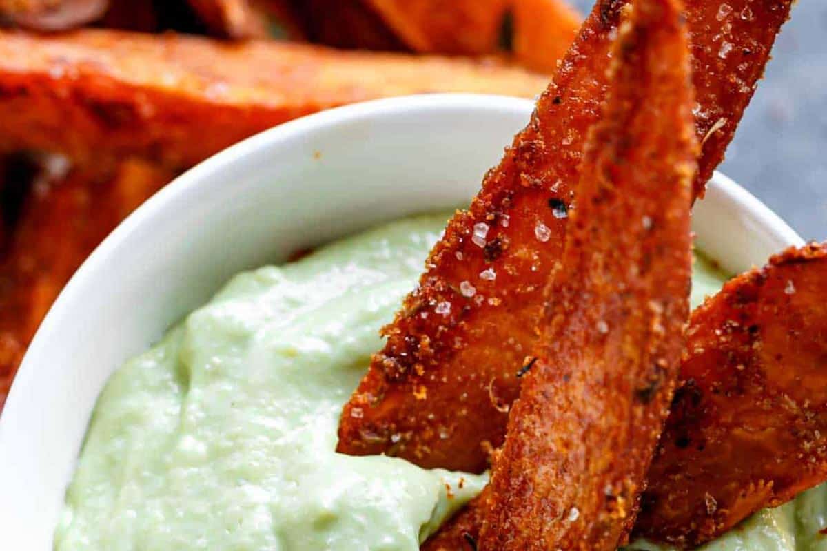 Close-up shot of Crispy Sweet Potato Wedges with Garlic Avocado Aioli.