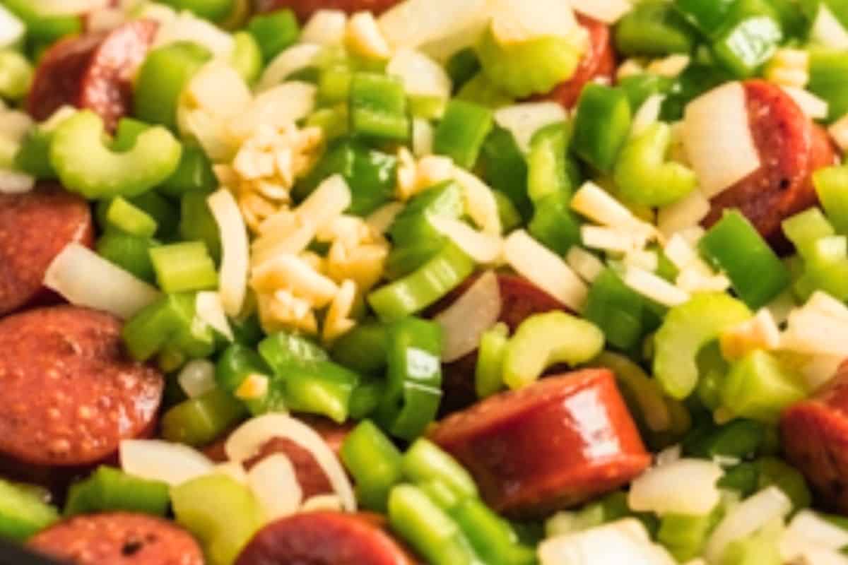 Add chopped onion, bell pepper, celery, and garlic to the pot.