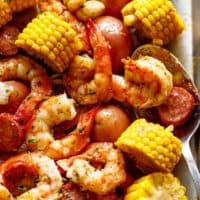 zoom in image of Shrimp boil on a tray with a tablespoon.