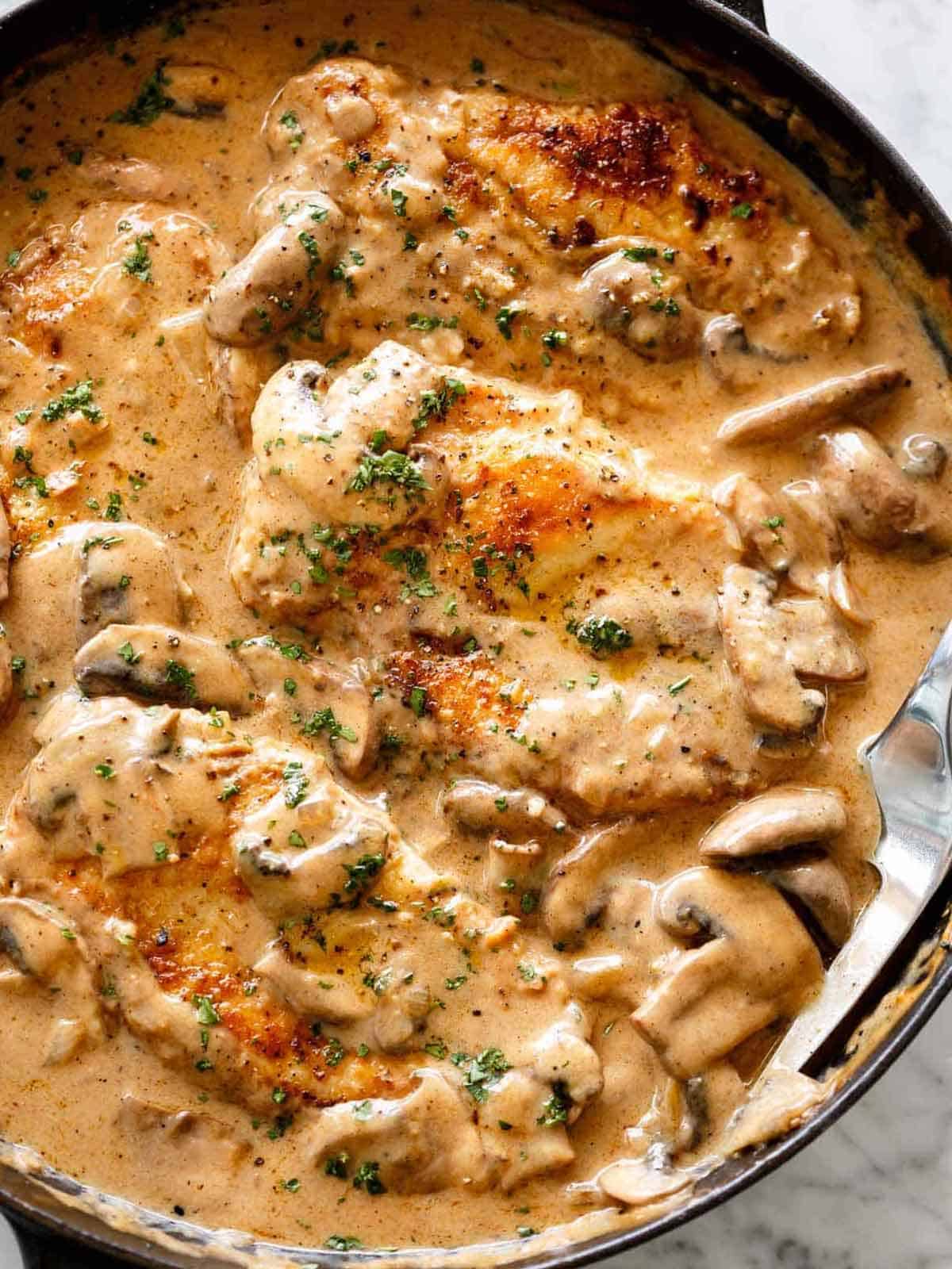 creamy Chicken Stroganoff in a creamy mushroom gravy inside a black pan