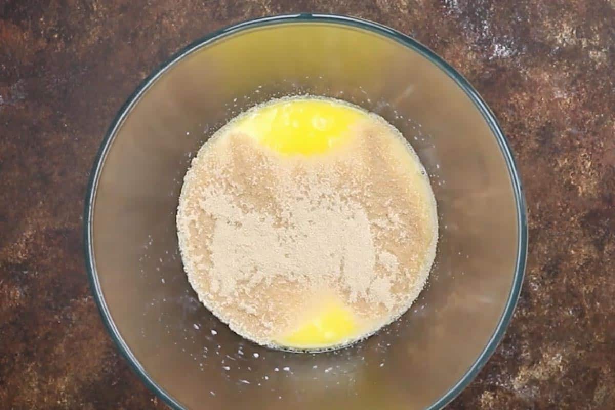 Whisked Milk, melted butter, sugar, and yeast in a bowl.