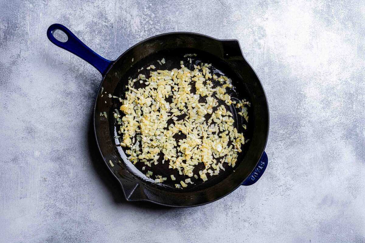 onion being sauteed in a pan until translucent