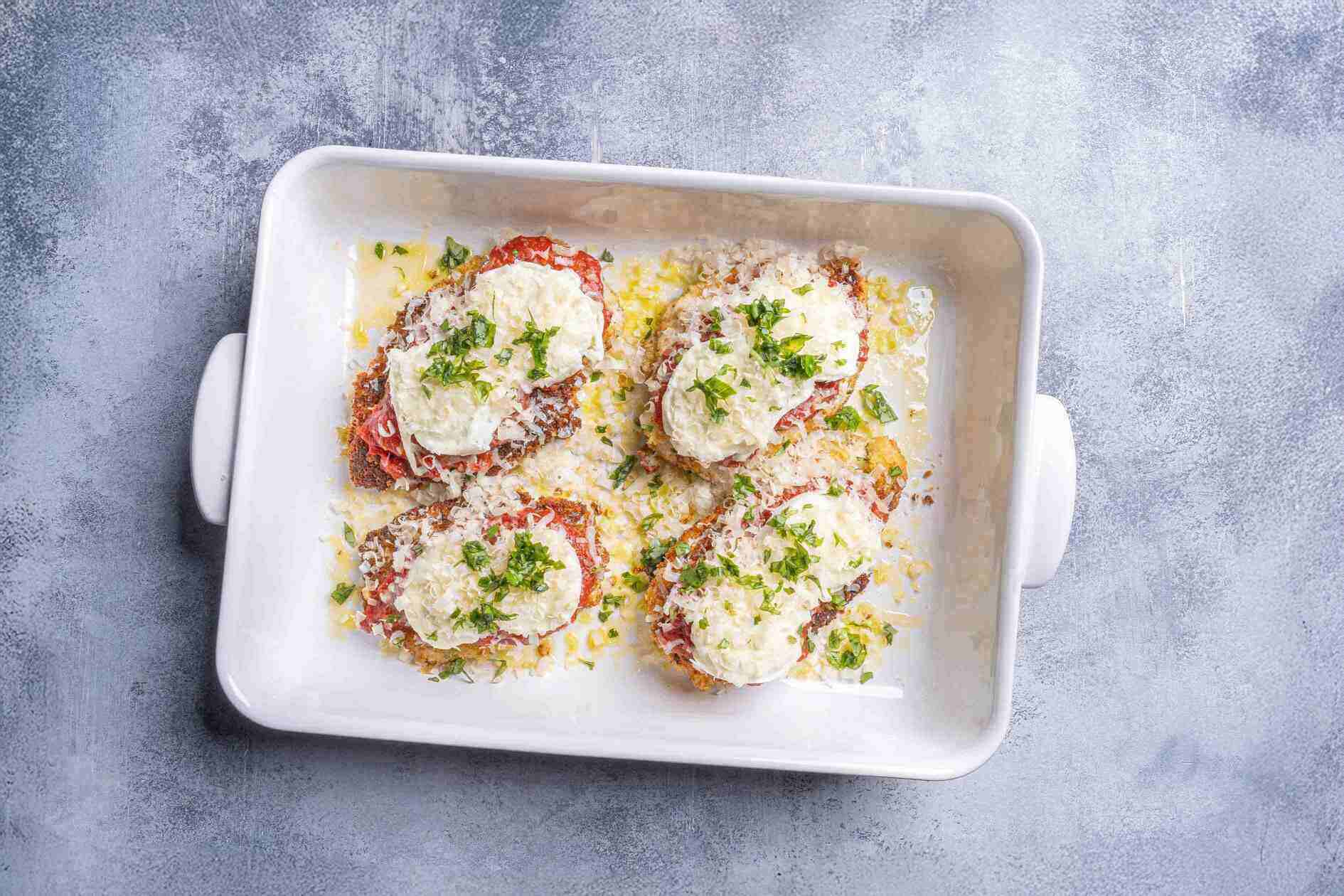 chicken breasts being composed and ready to be put in the oven