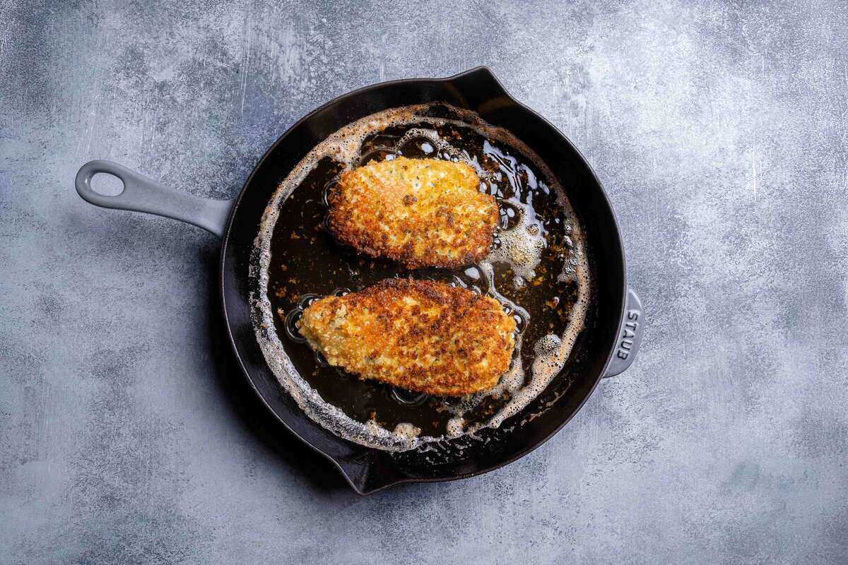 breasts being cooked in a skillet