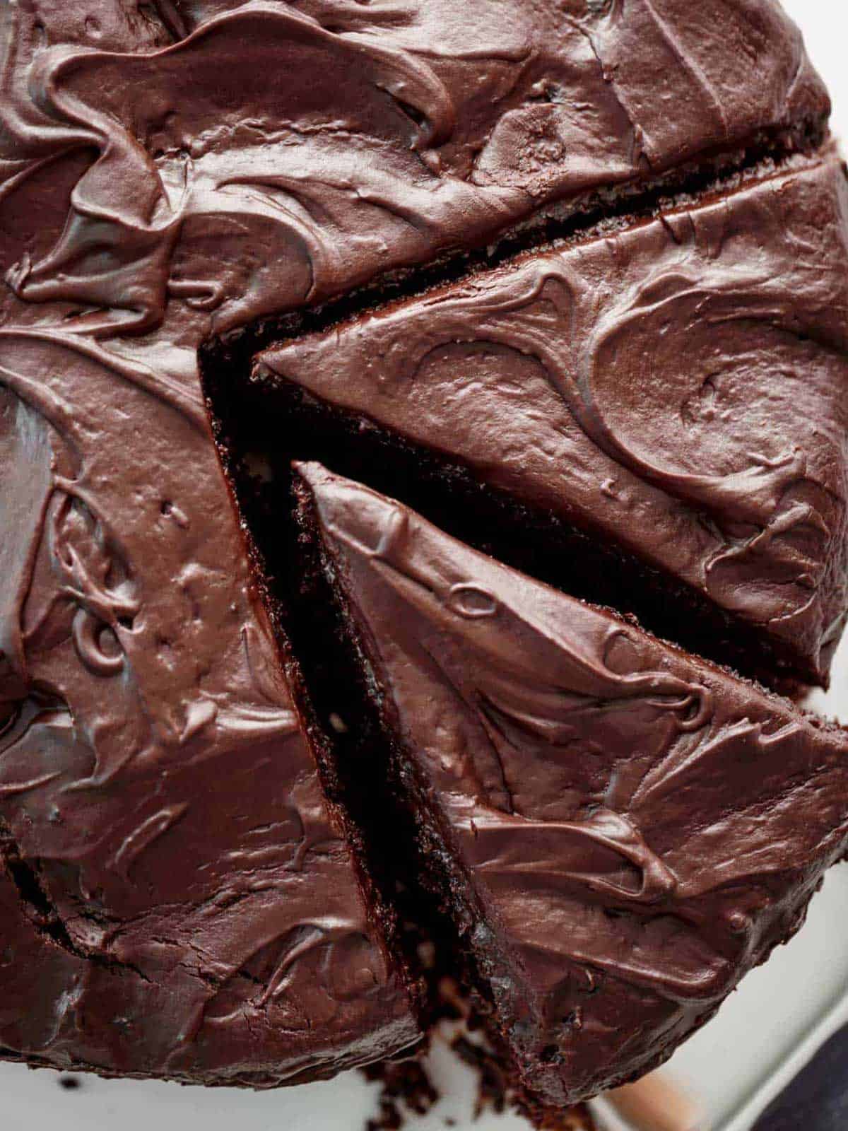 sliced chocolate cake #chocolate #cake #hersheys A thick chocolate cake lathered with chocolate butter cream with two pieces cut ready for serving