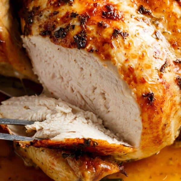 An image of golden garlic herb butter chicken just taken out of the oven and ready to be served.