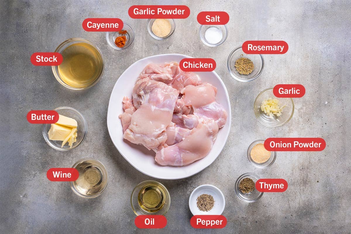 This image shows the ingredients needed for the preparation of the recipe, specifically: boneless chicken thighs, garlic powder, salt, rosemary, garlic, onion powder, thyme, pepper, oil, wine, butter, stock, cayenne.